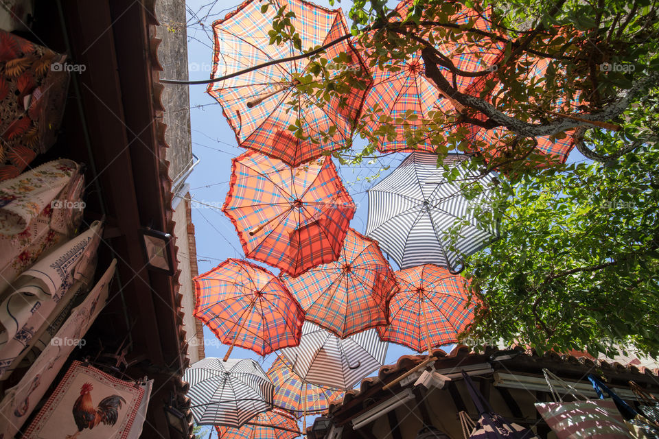 Roof made of umbrellas in an outdoor street market.