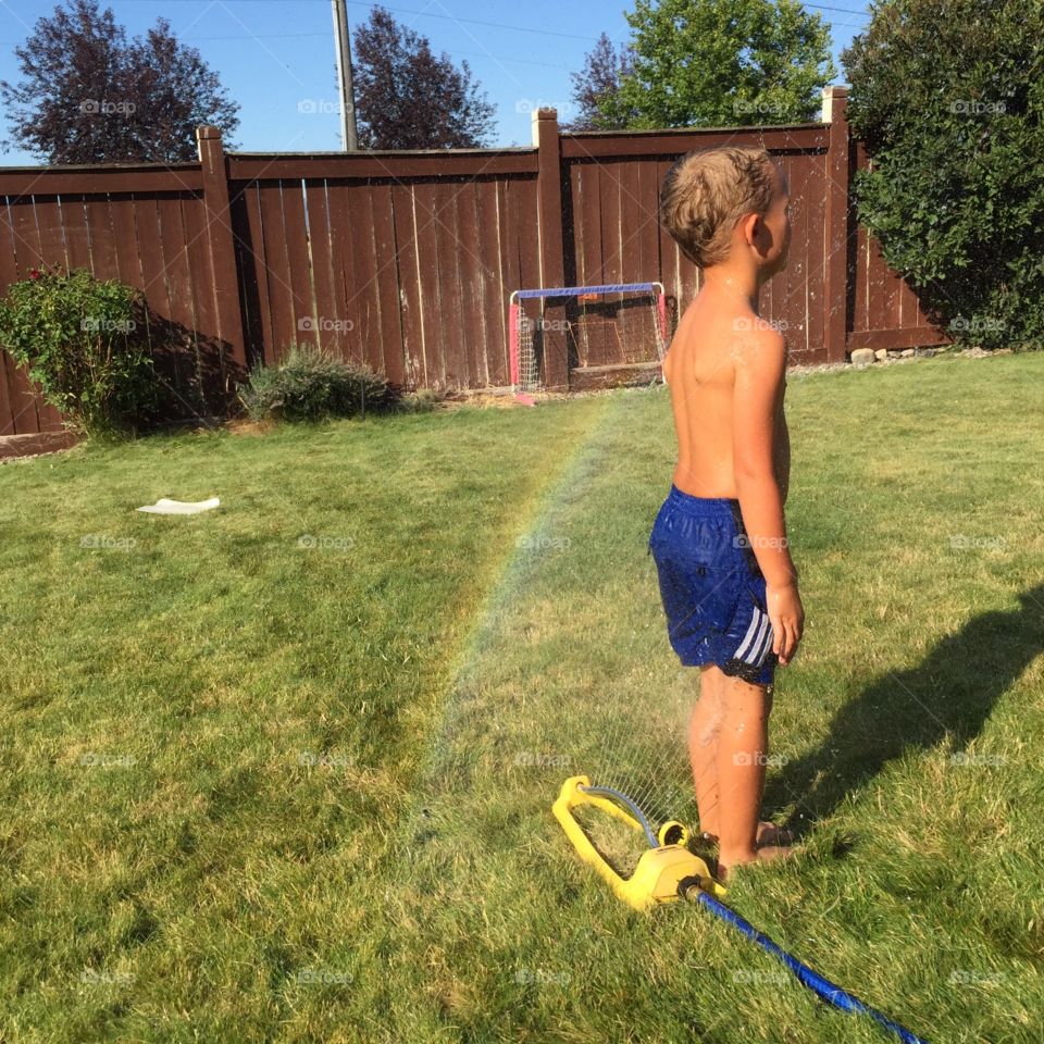 Boy in the sprinkler