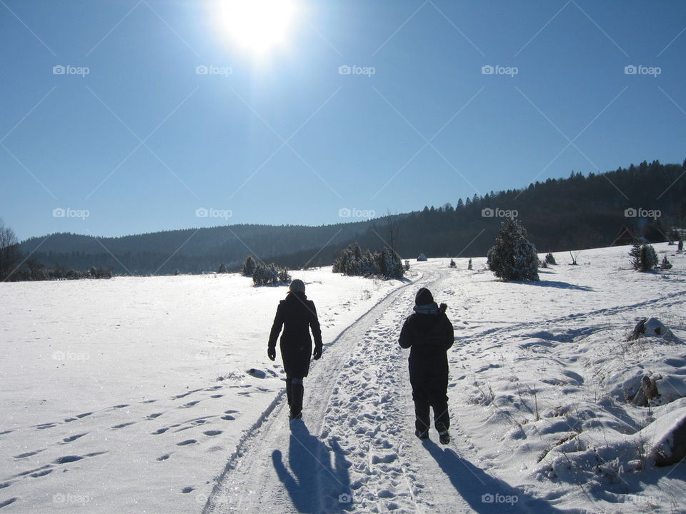 two woman on the snowy road