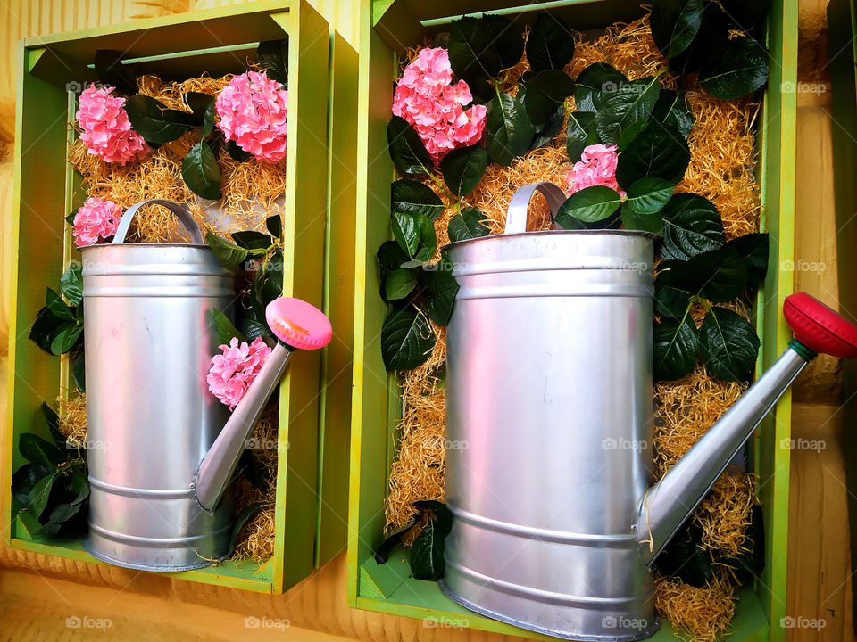 Two watering cans for watering flowers