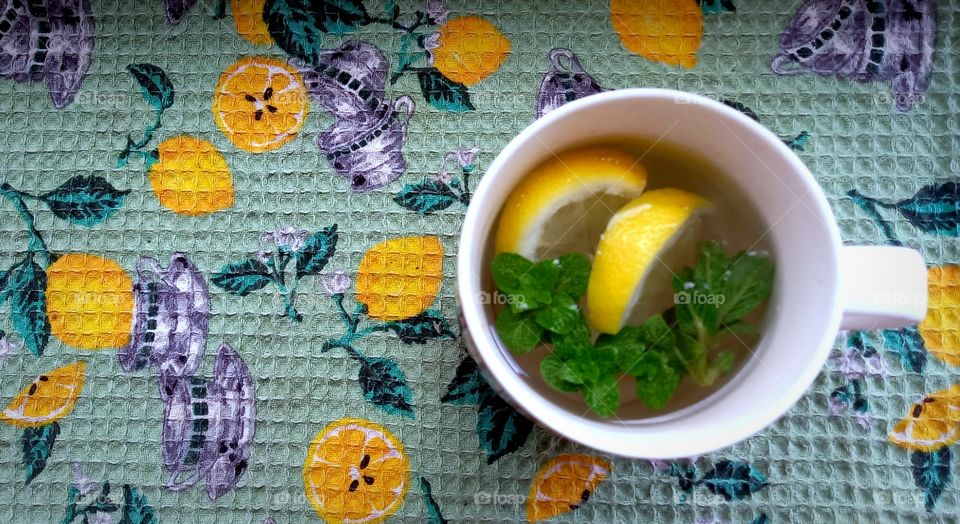 a cup of tea with lemon and mint