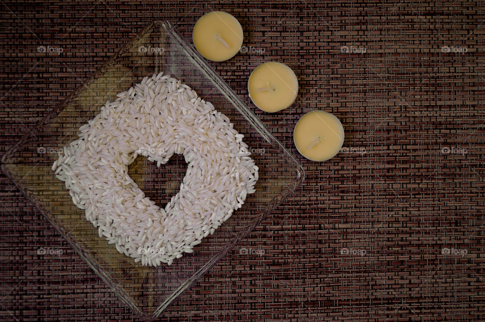 rice and candles in a brown table