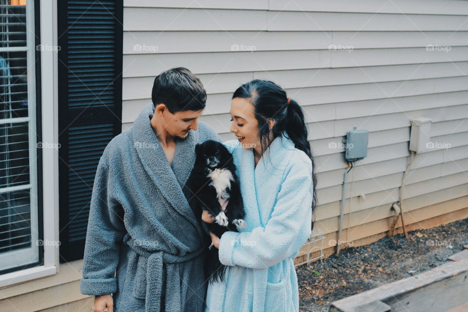 couple in robes with dog