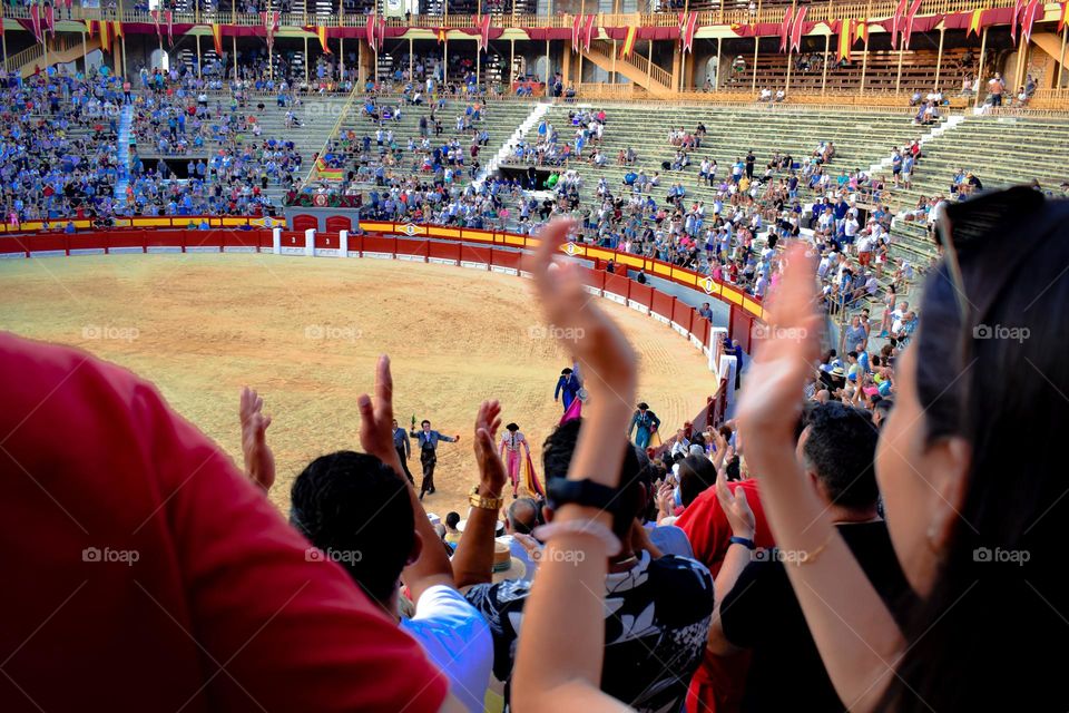 People applauding at an arena