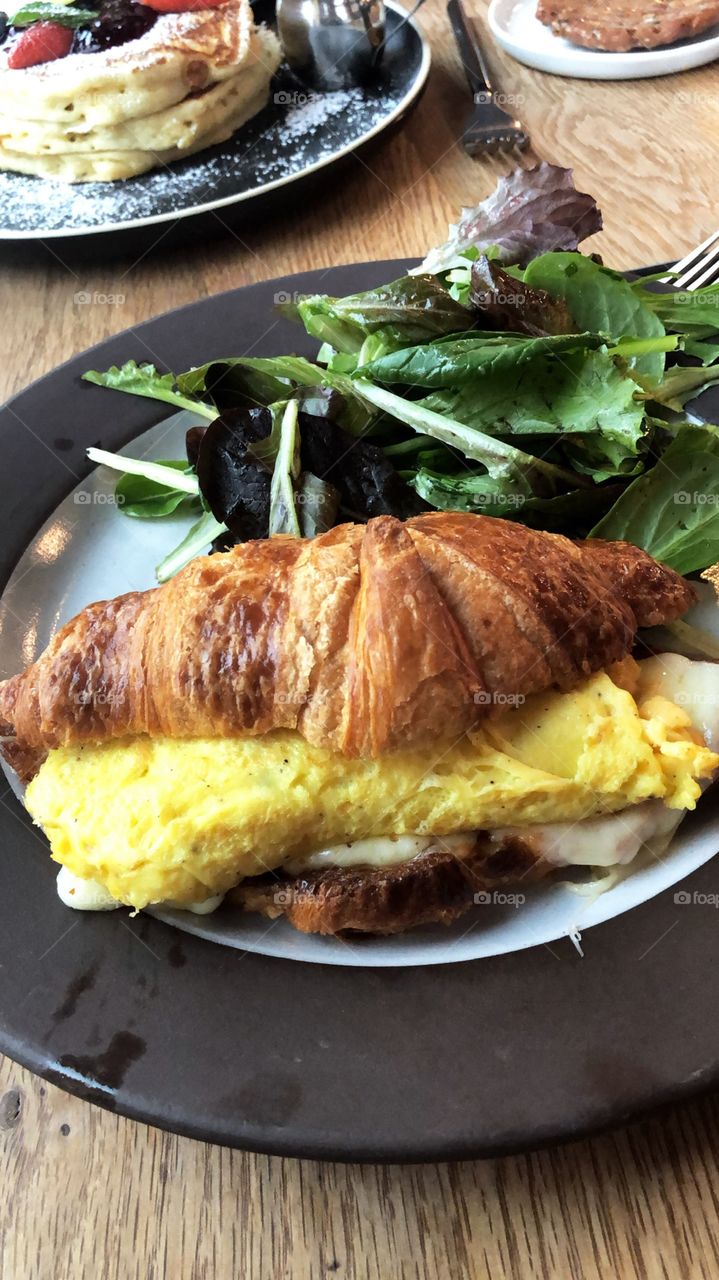 Egg and cheese on a buttery croissant 
