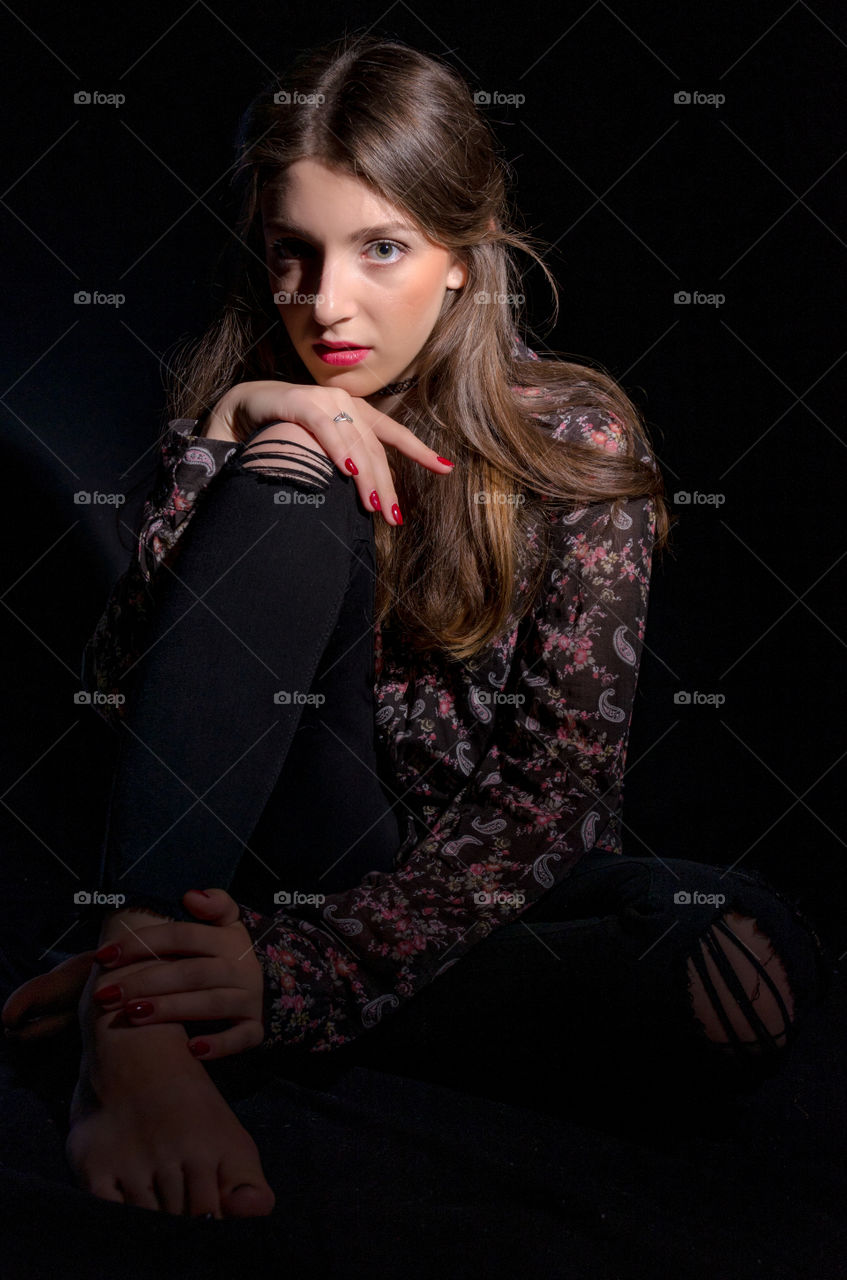 Portrait of a beautiful young woman on black background