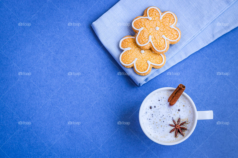 Top view to cup with coffee and some cookies.