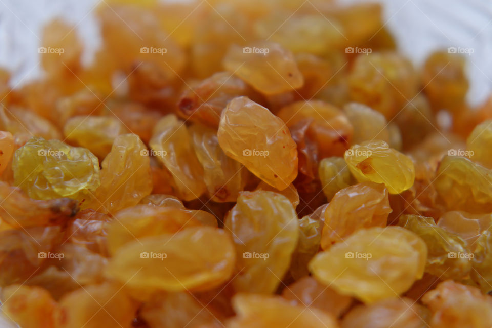 Sweet yellow raisins in a crystal vase. Dried white grapes  - amazing dessert.