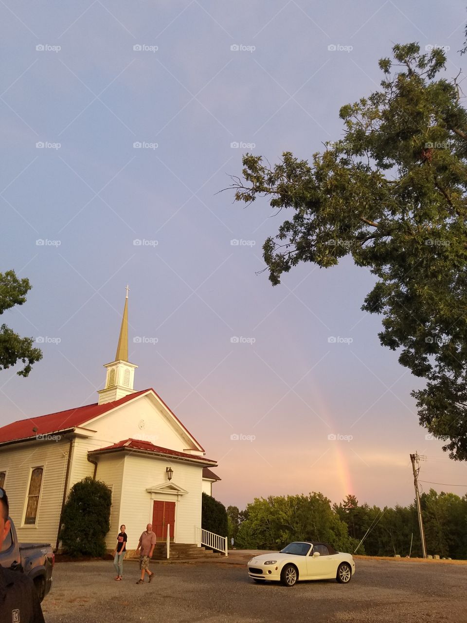 Rainbow over country church 