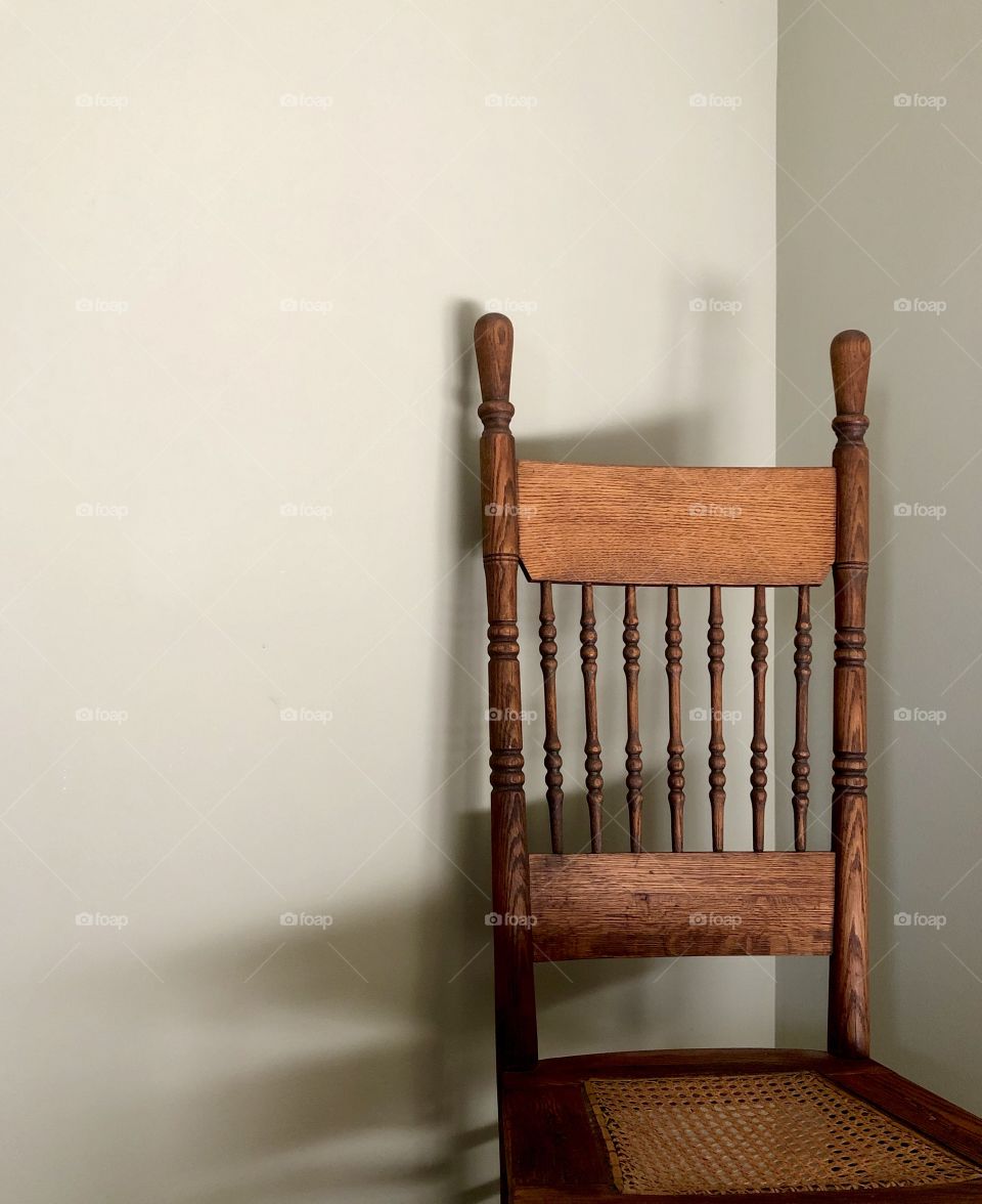 Antique wooden chair in corner 