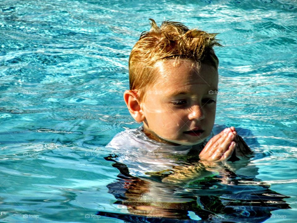 boy thinking in water