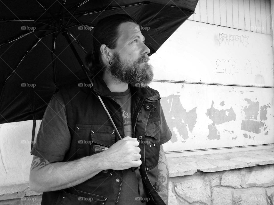 Man in black and white with umbrella