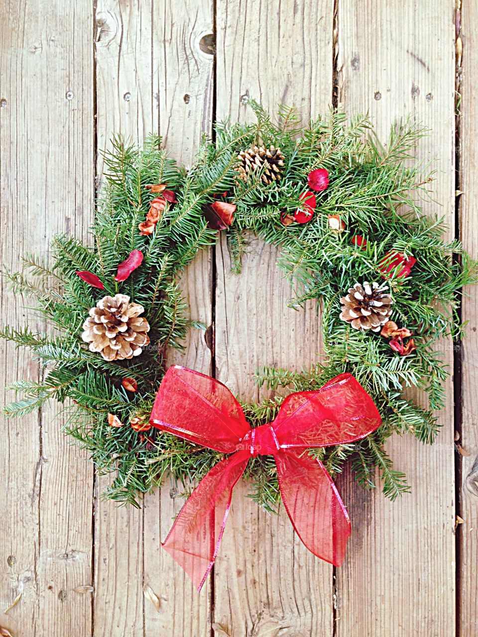 Homemade Christmas wreath with big red bow 