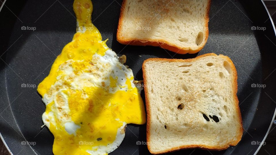 Yellow omelette, Beautiful yellow, yellow food, colour, beautiful yellow and white colour omelette with toasted brown bread in a black pan