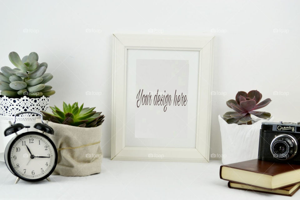 Styled desktop featuring book,succulent plant pots and a white frame perfect to display print and art.You can overlay text or image,Facebook header and blog post or to promote your product in your online website.