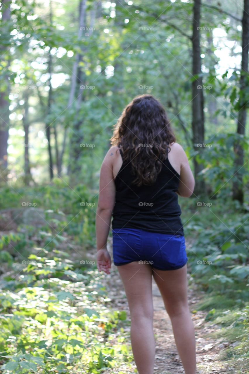 Young woman hiking through the forest