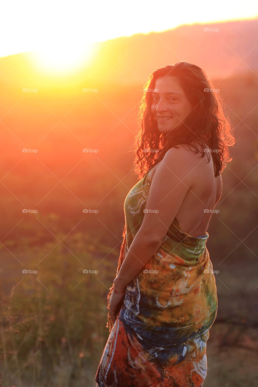 Beautiful woman posing against the sunset