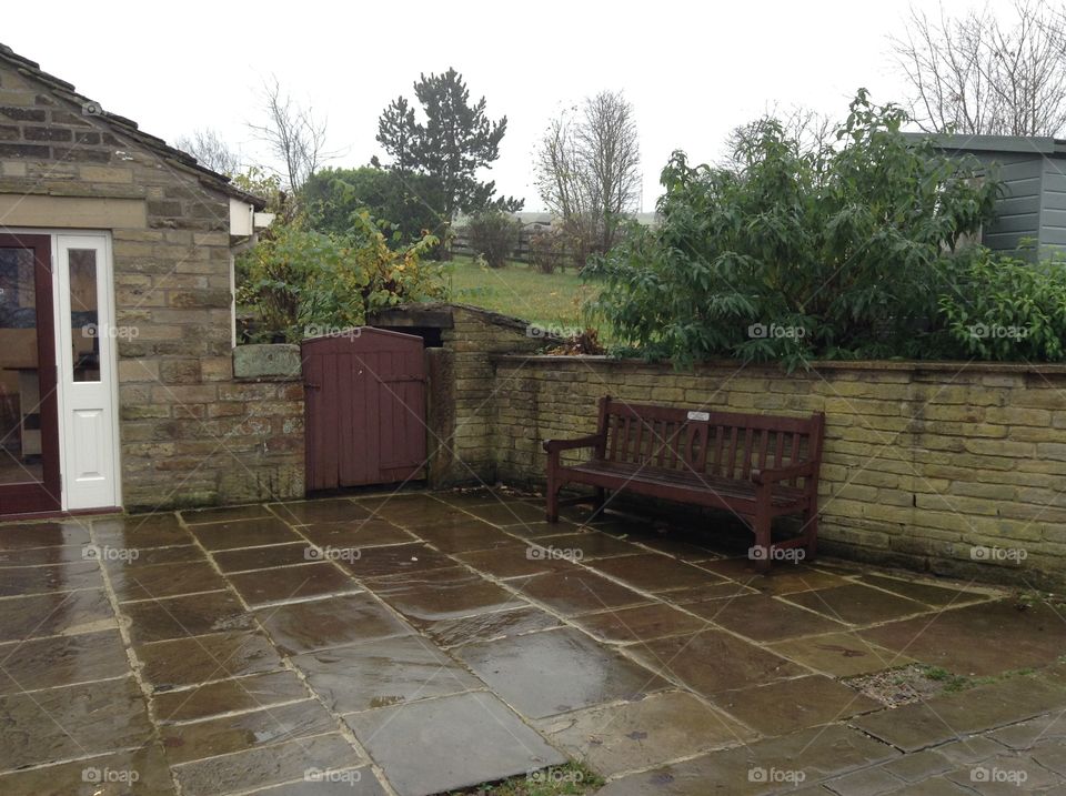 Wet floors and empty backyards telling us a story about rainy days in England 