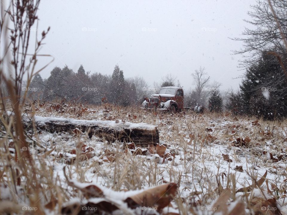 an old vehicle in a field in winter