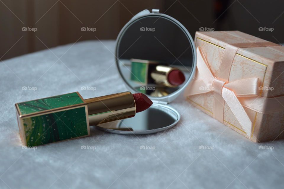Decorative cosmetics for the face, for bright makeup, red classic lipstick and mirror, makeup sticks, girls' and women's makeup