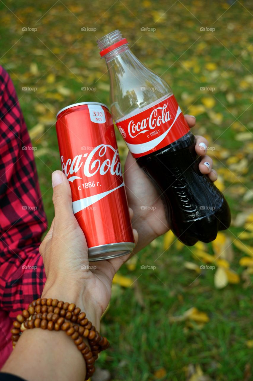 coca cola in the hands fall beautiful texture background