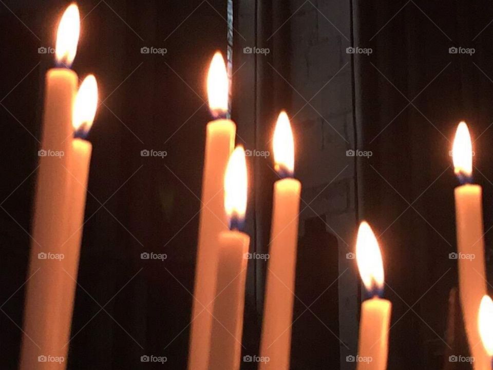 Candles burn, for those who lost their lives in WWII, in cathedral in Cologne, Germany 