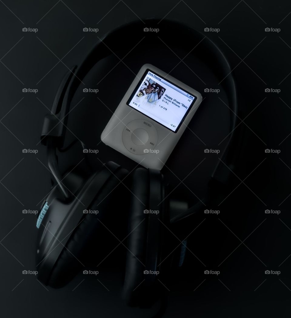 iPod & headphones on a black background 