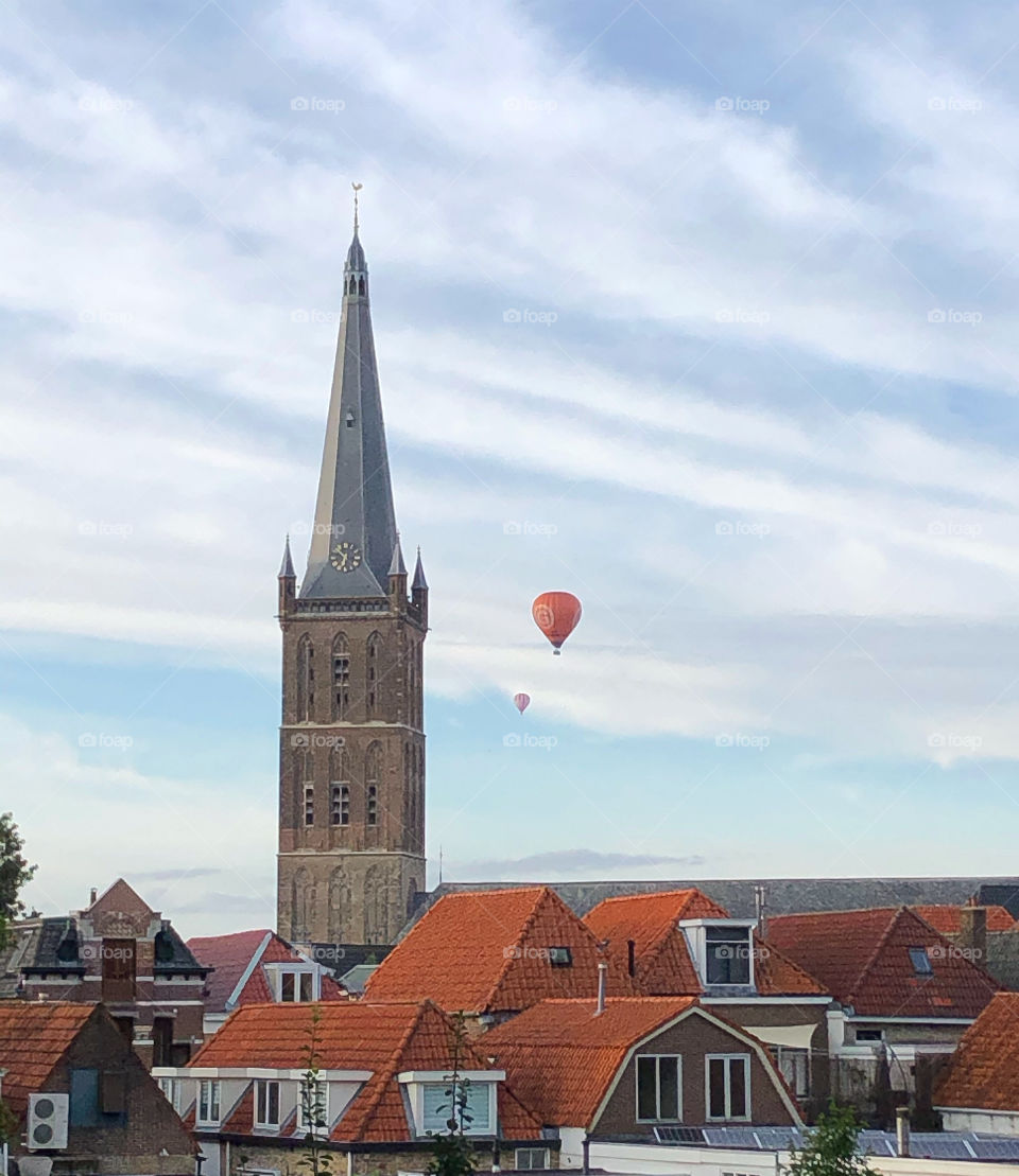 Hot air balloons near church