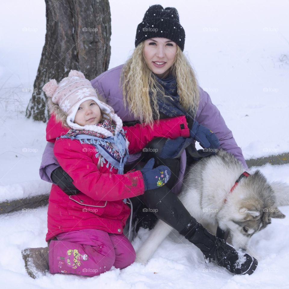 mother with daughter and dog husky