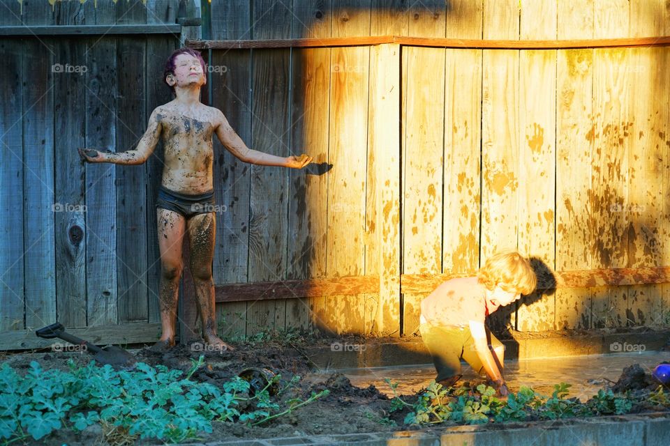 Kids Playing In Mud