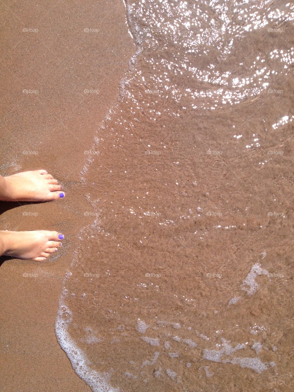 Sand and water between the toes 