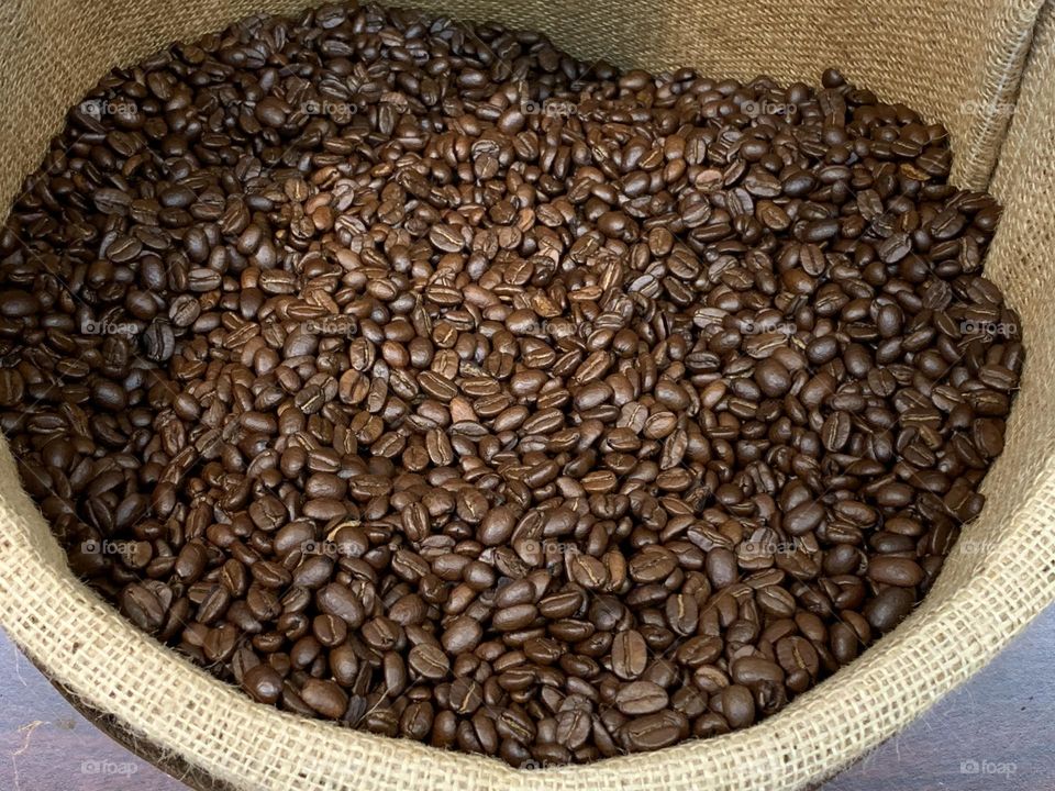 Coffee beans on a burlap sack.