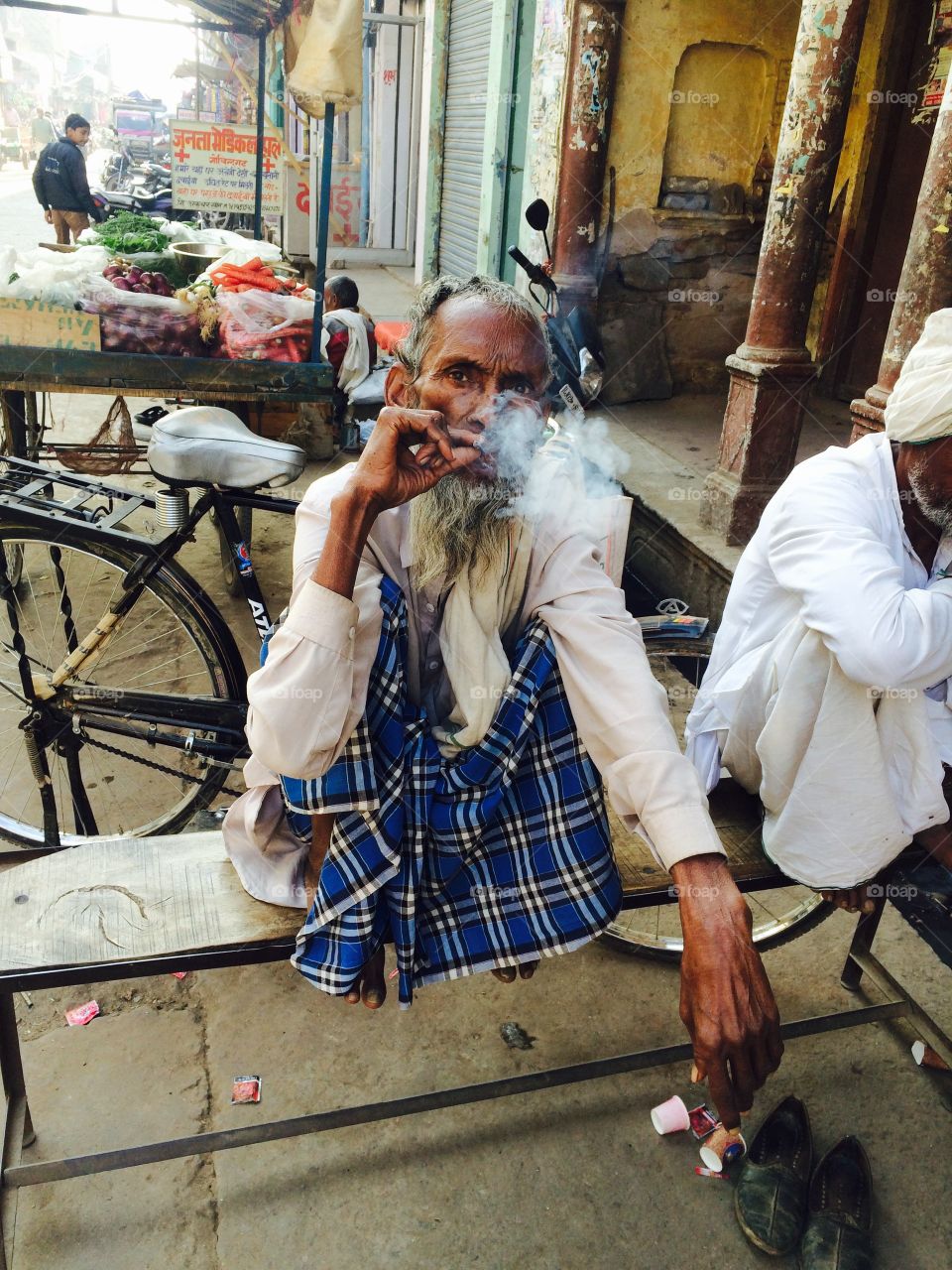 Old man in smoking and out to mouth smoke