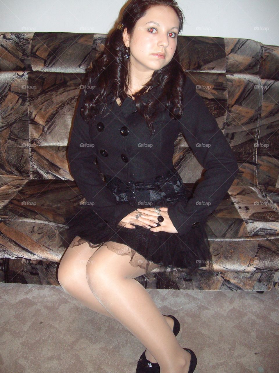 Young woman sitting on sofa