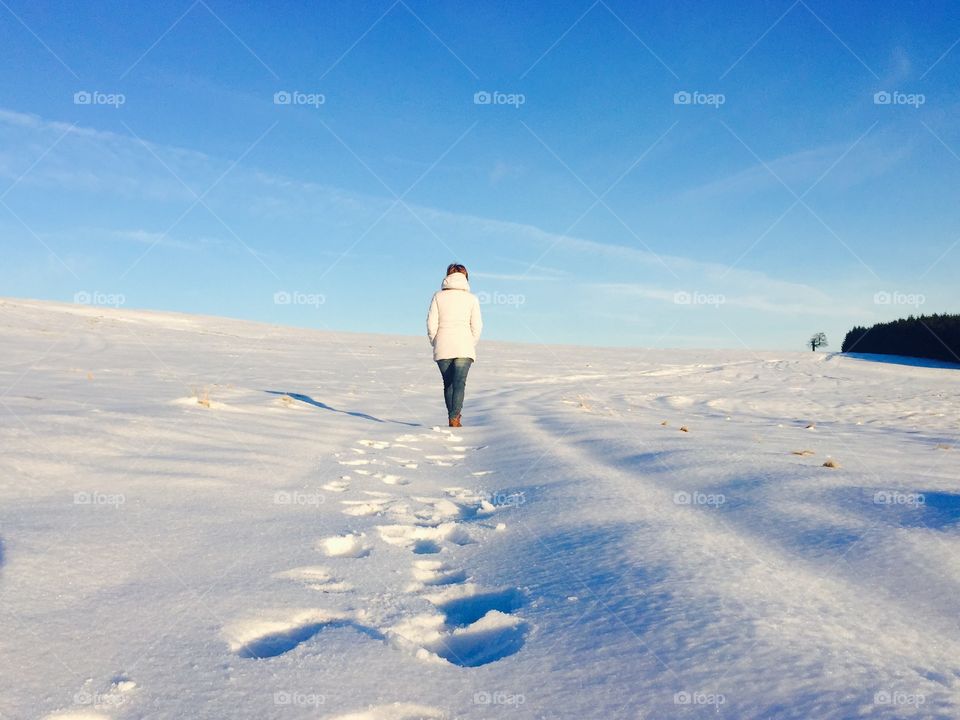 Hiker walkg on snow