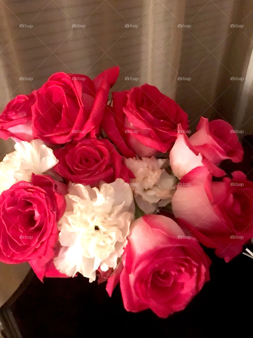 Bright pink roses and white carnations
