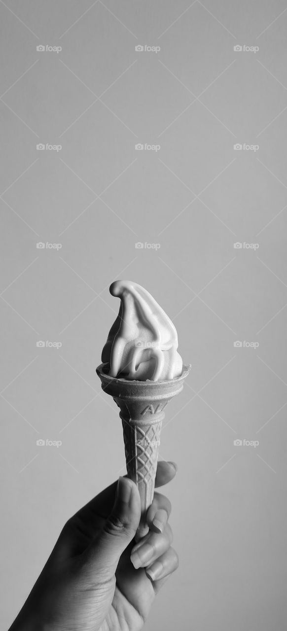 Holding ice cream in black and white