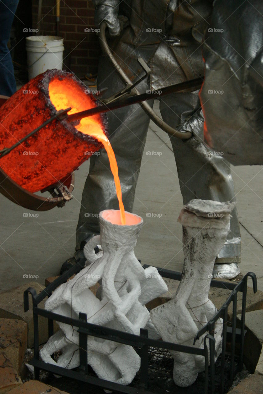 Pouring Bronze into colloidal silica sand molds 