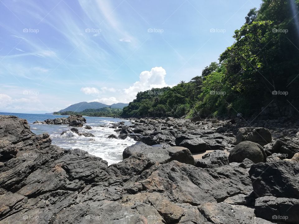 Volcanic coastline and rocky beach in Abra De Ilog, Mindoro, Island of Philippines