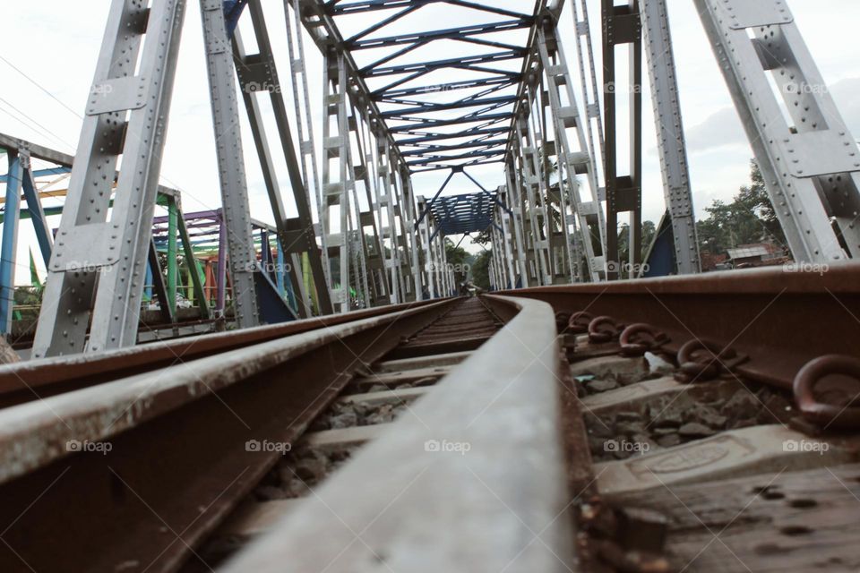 steel bars stretching as far as the eye can see this is a railroad track that connects from one area to another this line is passed by train every day with a specific purpose