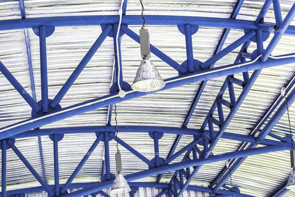 Lamp and blue ceiling structure. Lamp hanging under the blue ceiling structure steel