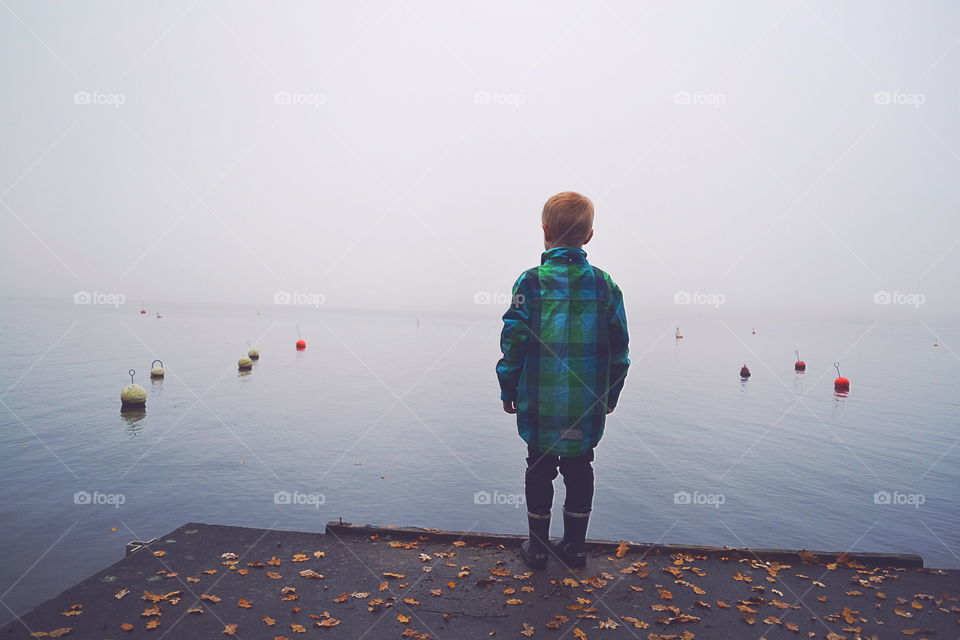 Boy at an foggy lake