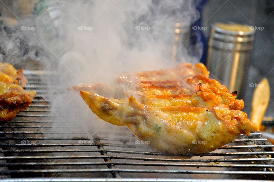 Honey chicken wings on barbecue