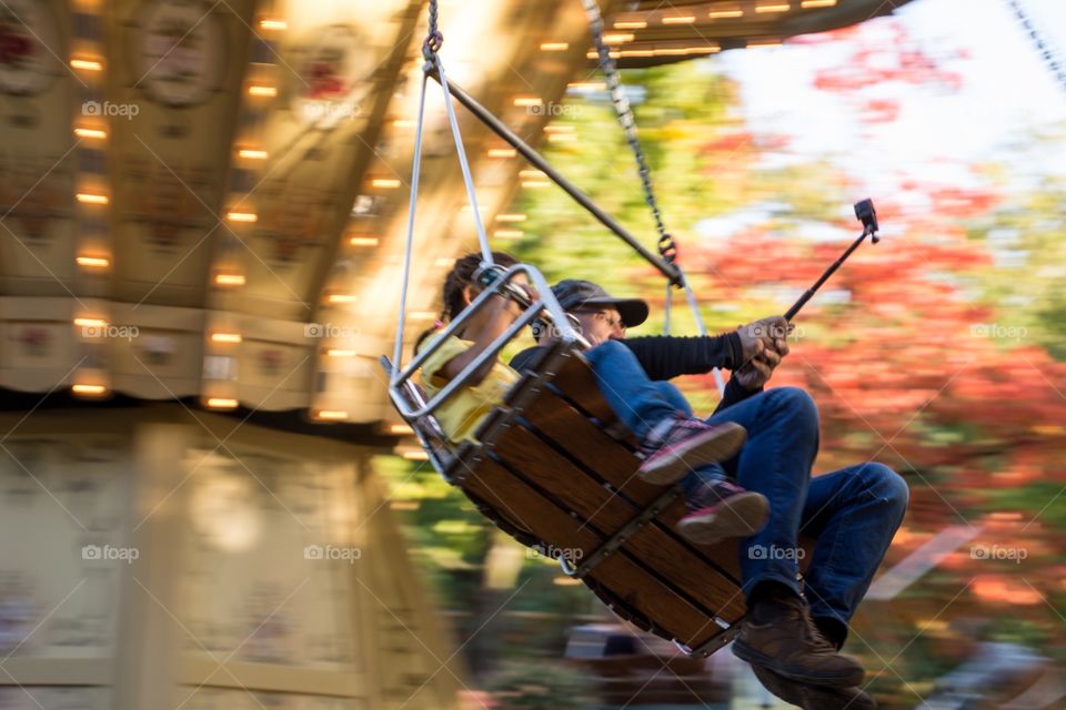 A father with his daughter in a carnival ride with the GoPro 