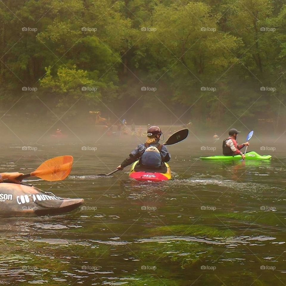 whitewater kayakers paddling on a Misty morning on the Hiwassee River