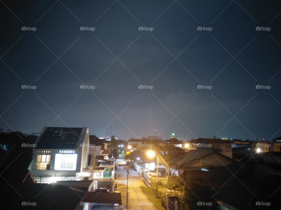 time is very quiet midnight in one of the residents of the city of Padang, West Sumatra, Indonesia, so quiet that there is only the sound of the night and the city lights at night