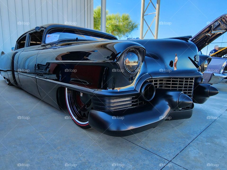 A custom Cadillac is a hot rodders dream with a expensive deep paint job, black chrome, modified sheet metal and aggressive stance
