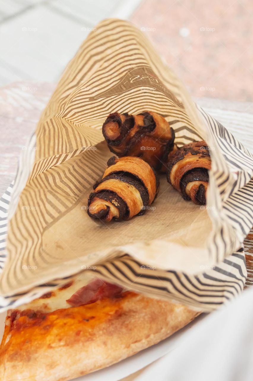 Appetizing cakes lie in a paper bag
