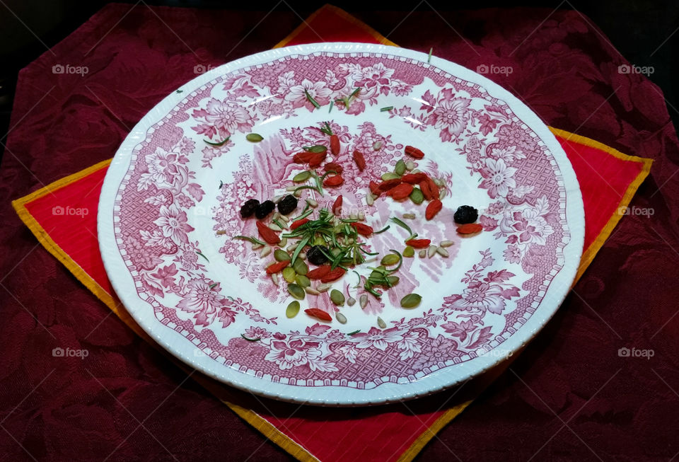 Herbs, seeds and dry fruit on a plate