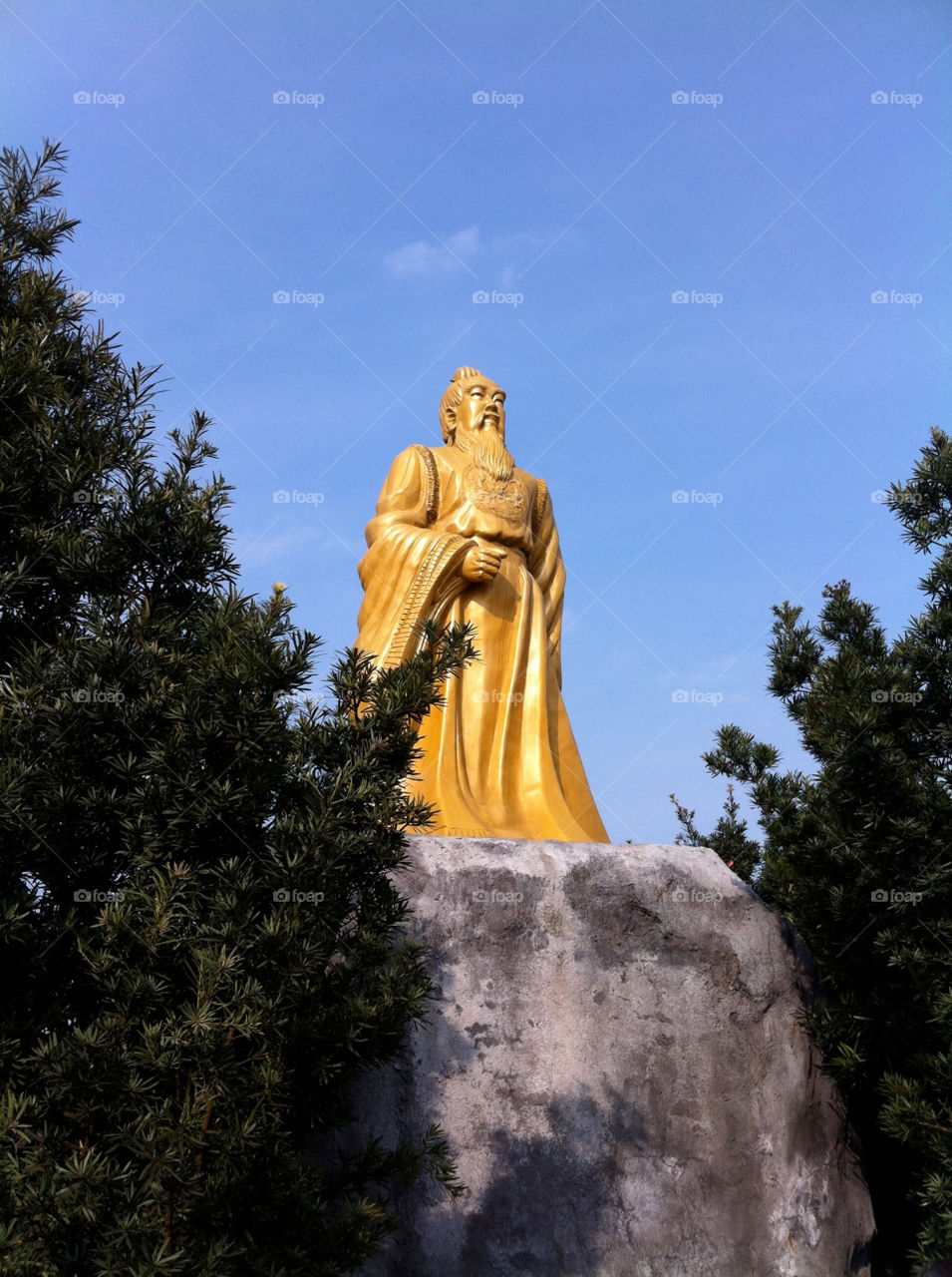 A gold statue at the top of the mountain.